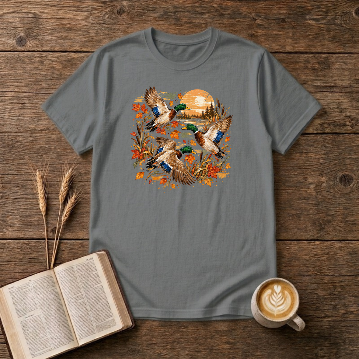 Ducks at Sunset design with three mallard ducks in flight over autumn leaves, golden reeds and a sunset on a Graphite Heather unisex T-Shirt