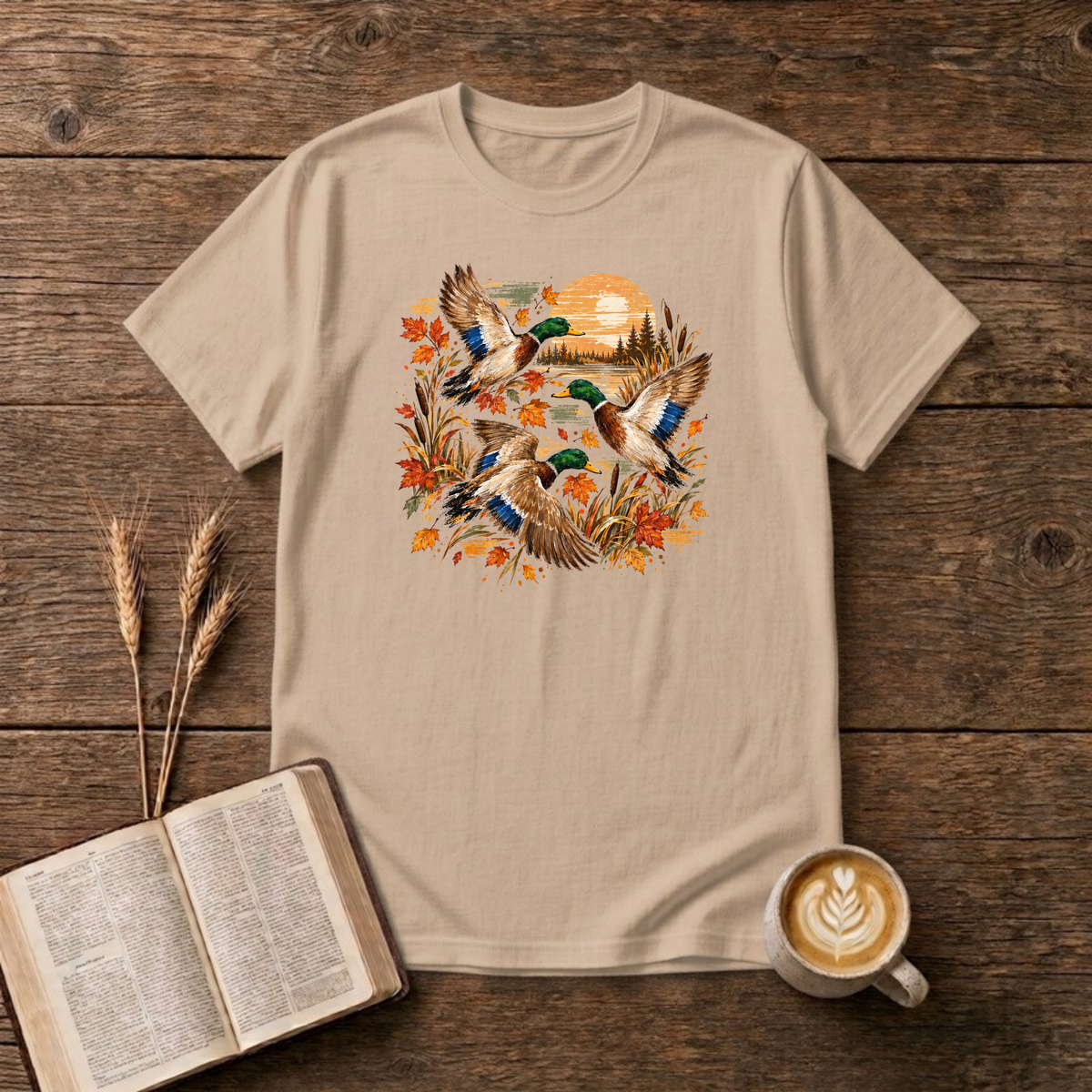 Ducks at Sunset design with three mallard ducks in flight over autumn leaves, golden reeds and a sunset on a Natural unisex T-Shirt