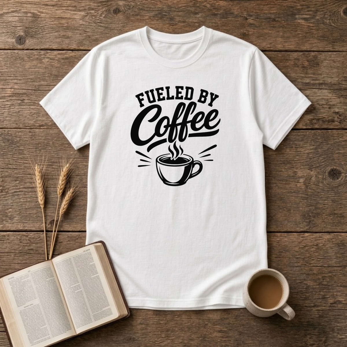 Fueled by Coffee design with black arched lettering above a steaming cup of coffee on a White unisex T-Shirt