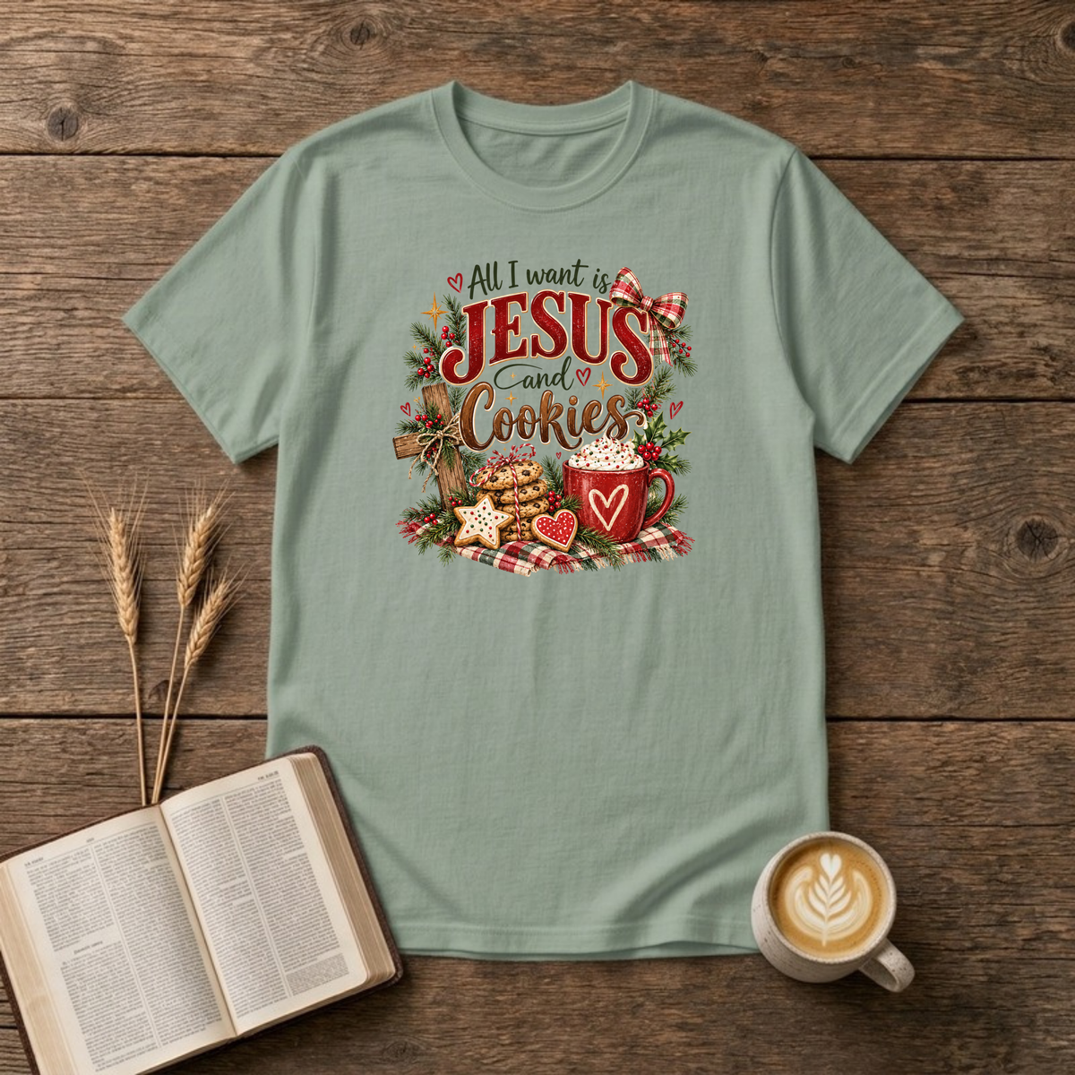 All I Want Is Jesus and Cookies design with a wooden cross, stacked cookies and a mug of cocoa on a Sage unisex T-Shirt