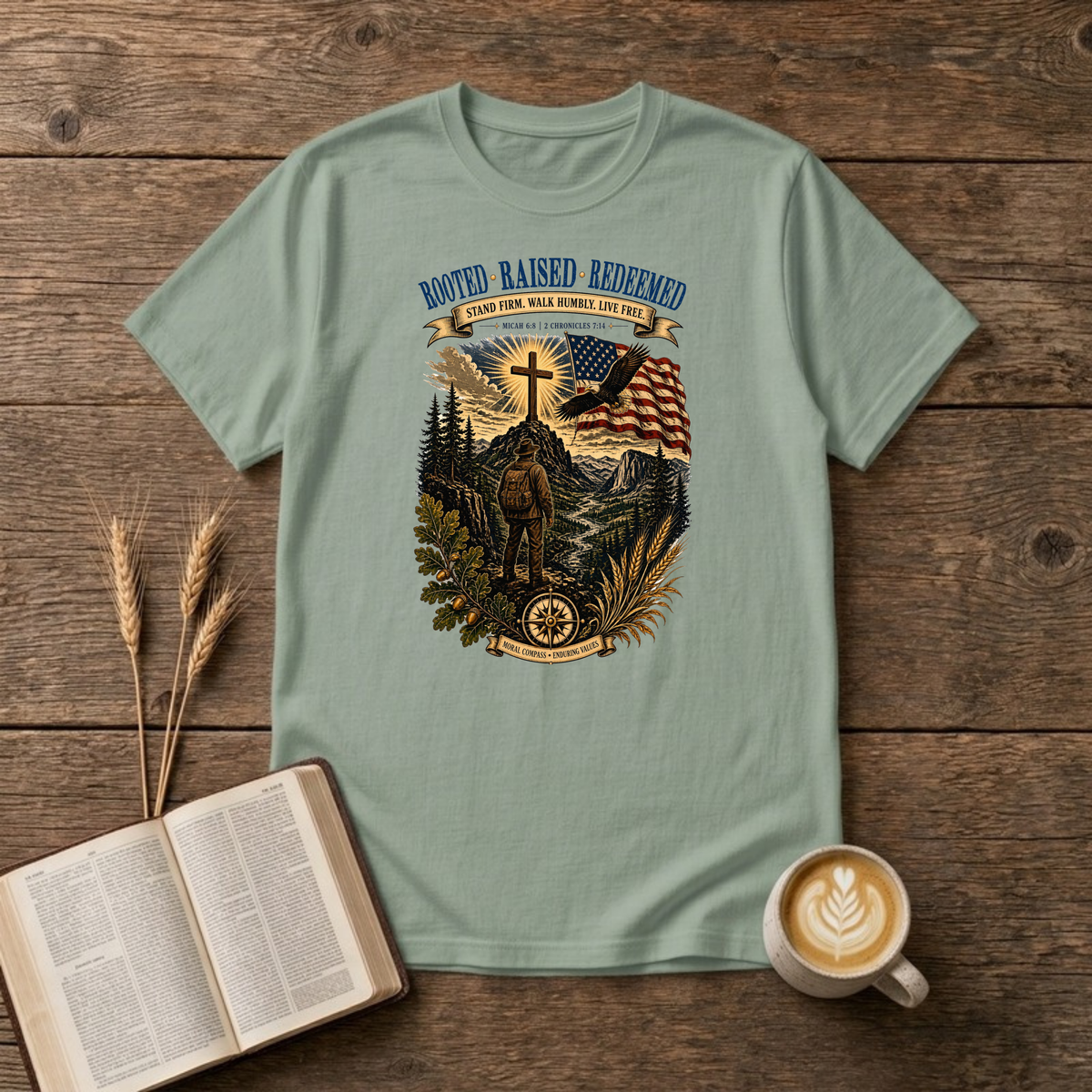 Rooted. Raised. Redeemed. mountain scene with a hiker, cross, waving flag and eagle on a Sage unisex T-Shirt