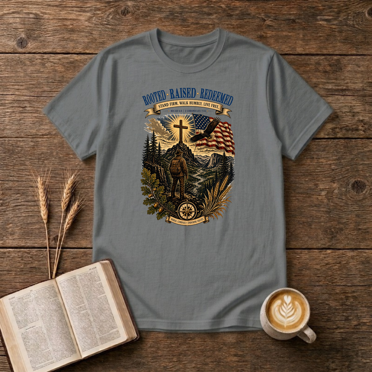 Rooted. Raised. Redeemed. mountain scene with a hiker, cross, waving flag and eagle on a Graphite Heather unisex T-Shirt