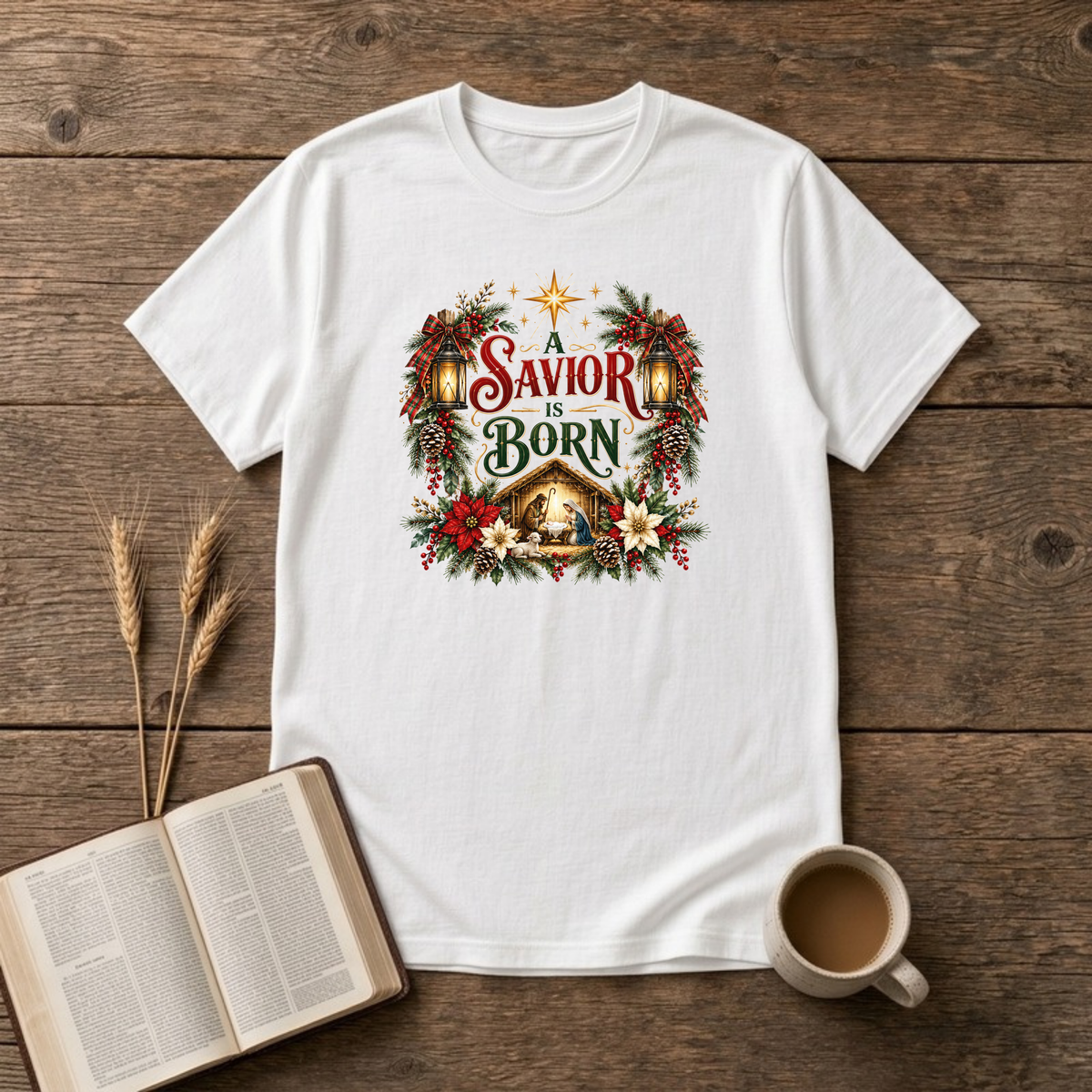 A Savior Is Born nativity wreath design with red and white poinsettias, holly and a lit stable scene on a White unisex T-Shirt