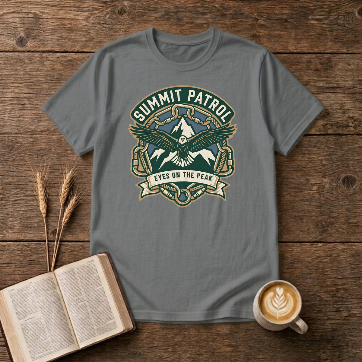 Summit Patrol design with an eagle, snow peaks and a ribbon reading Eyes On The Peak on a Graphite Heather unisex T-Shirt.