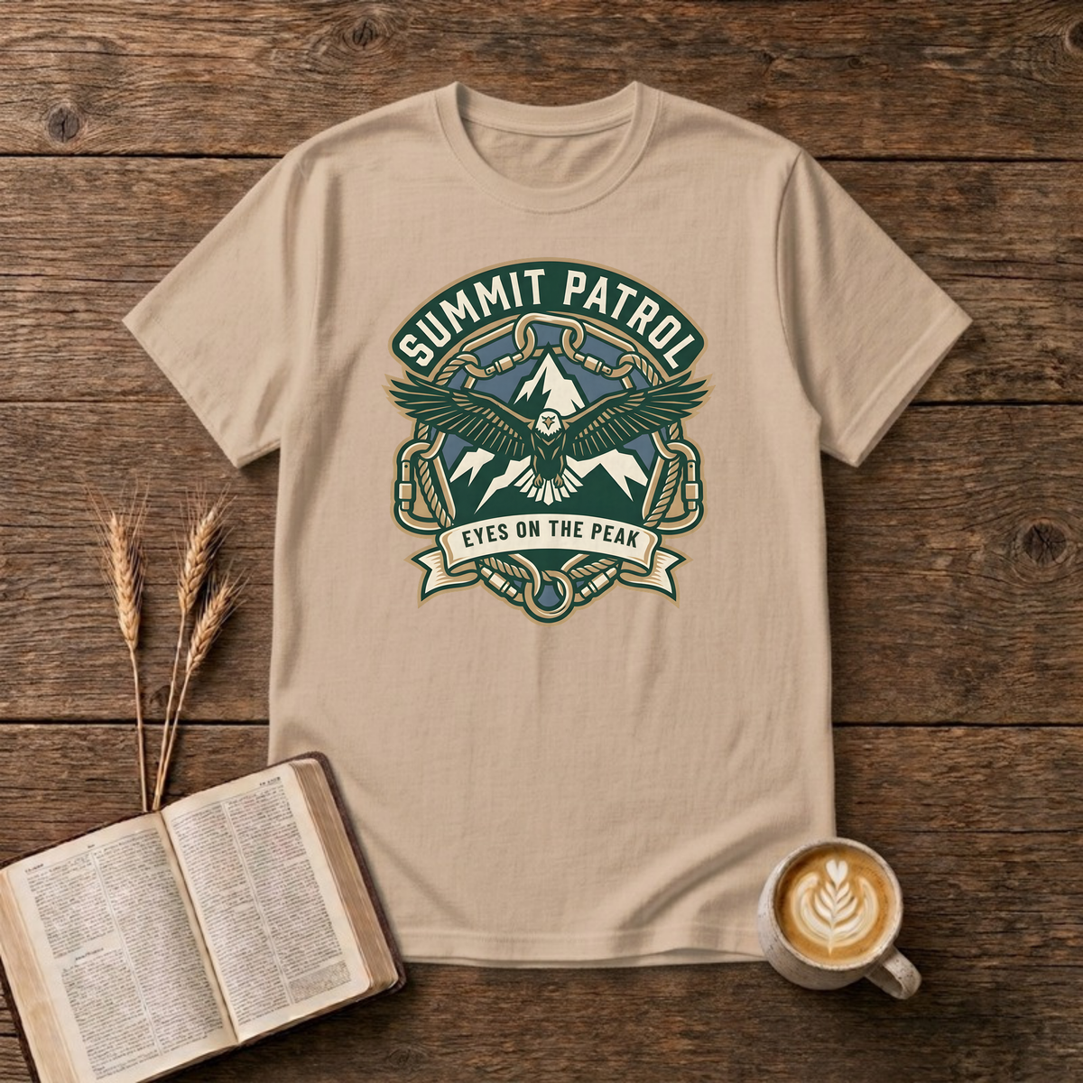 Summit Patrol design with an eagle, snow peaks and a ribbon reading Eyes On The Peak on a Natural unisex T-Shirt.