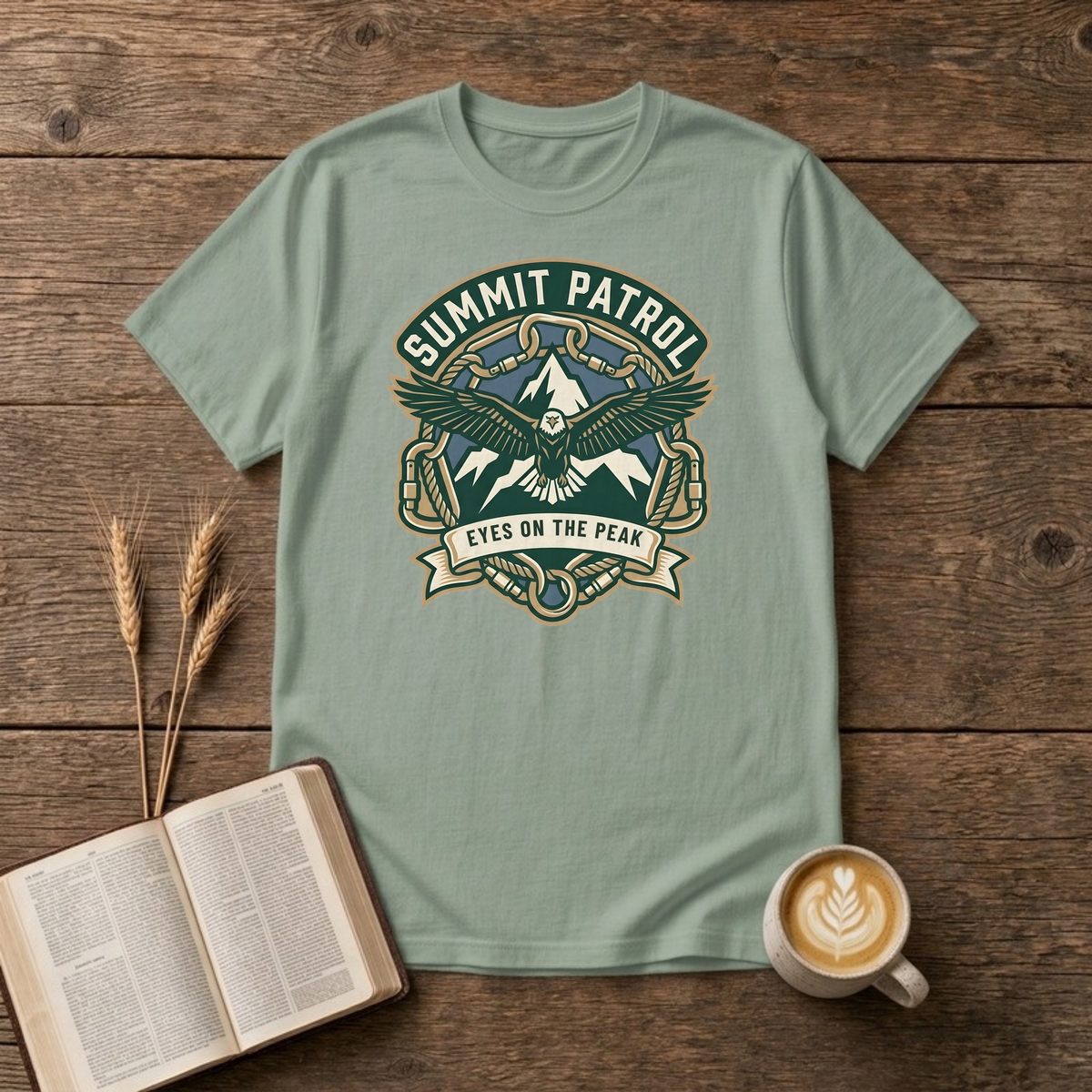 Summit Patrol design with an eagle, snow peaks and a ribbon reading Eyes On The Peak on a Sage unisex T-Shirt.