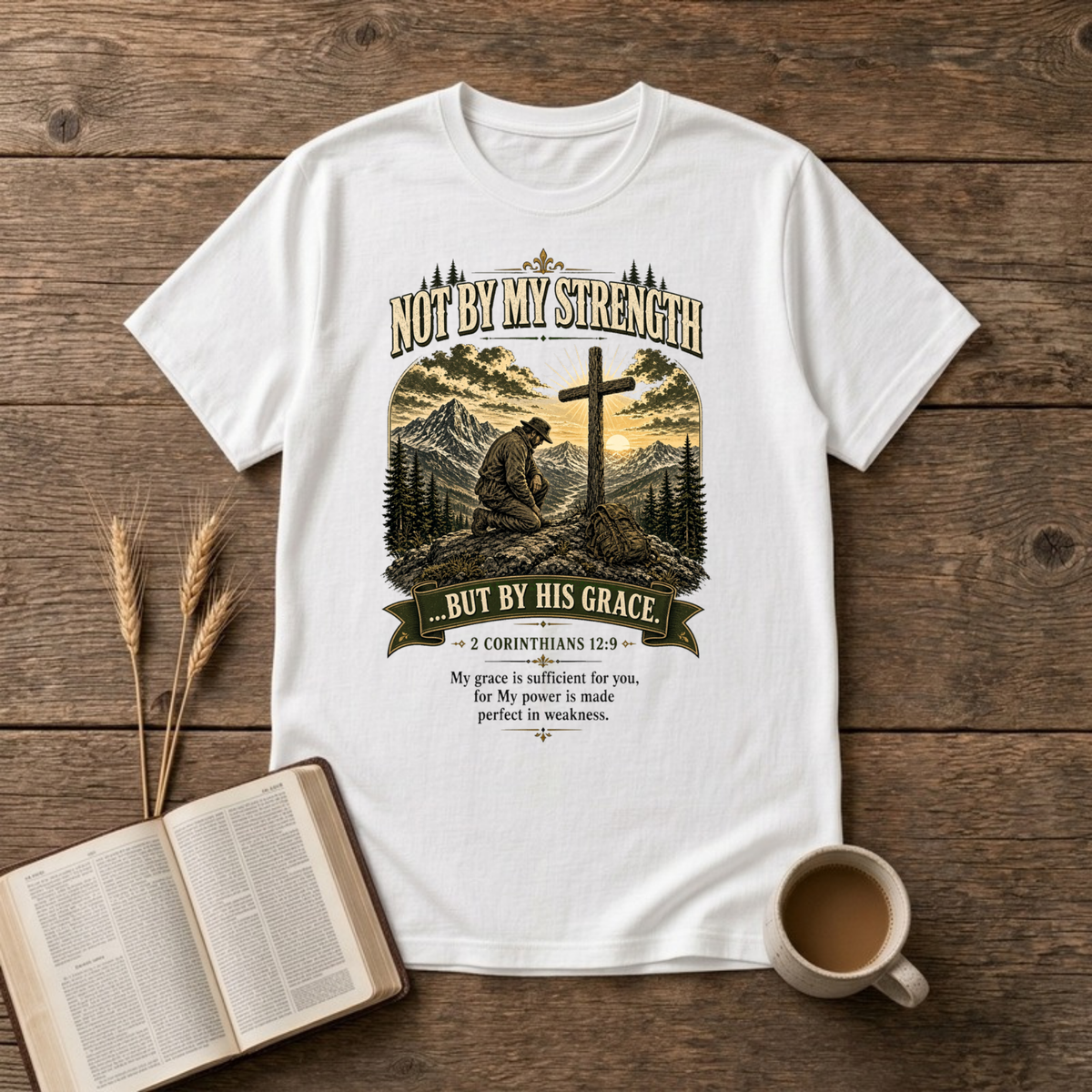Mountain scene with a wooden cross and the words Not By My Strength on a White unisex T-Shirt
